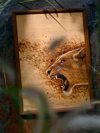 A powerful pyrography piece of a roaring lioness. The artist uses heat to create a sense of movement and raw emotion, making this wood burn artwork a captivating addition to any wall.