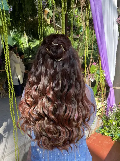 The back view shows the beautiful texture of the curls and the unique placement of the diamond string for a touch of sparkle.