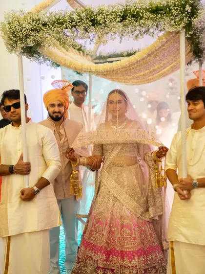 A beautiful multicultural wedding where the bride enters under a delicate phoolon ki chaadar. Even though rain moved us indoors, the moment was just as breathtaking.