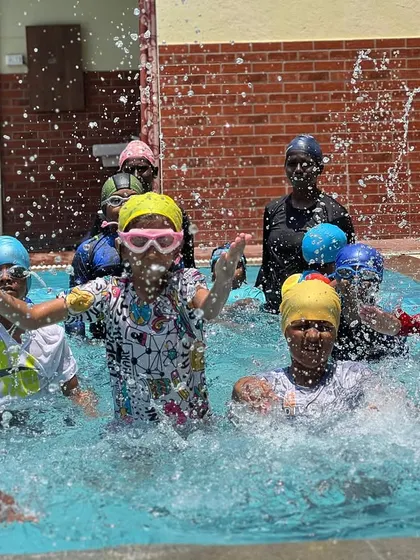 A snapshot of the energy and fun from one of our regular swimming classes. You can see our coaches right in the water with the kids, making a splash and learning together.