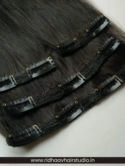 A detailed close-up of the secure clips on our straight hair extension set. These clips are lightweight yet strong, providing a comfortable hold without damaging your hair.