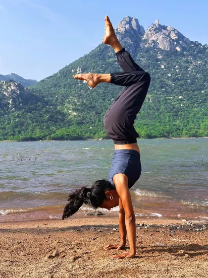 Stand tall like the mountains, on your hands. A scorpion handstand by the lake, feeling strong and connected to the landscape.