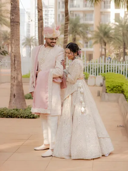A candid moment during a couple's portrait session. The soft pastel outfits and the gentle interaction make for a sweet, romantic photograph that feels natural and effortless.