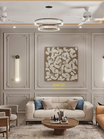 For this living area, I created a feature wall with classic European-style molding and modern sconce lighting. The neutral color palette allows the furniture and art to stand out, resulting in a space that feels both timeless and contemporary.