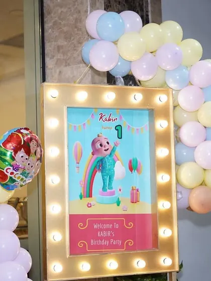 The welcome area for Kabir's party, with a lit-up sign and a JJ cutout to greet the guests.