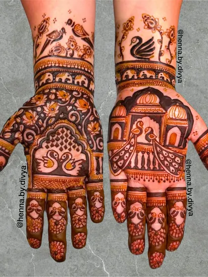 This design has a distinctly royal feel, with peacocks in jharokhas (windows), swans, and birds. The use of negative space makes the intricate figures stand out.