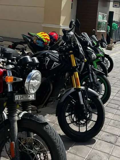 A row of bikes including Triumph and Kawasaki models, parked and ready for their riders to take a break. We're a popular spot for group rides.