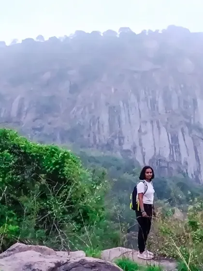 Another shot of a hiker posing before the majestic cliffs of Bananthimari.