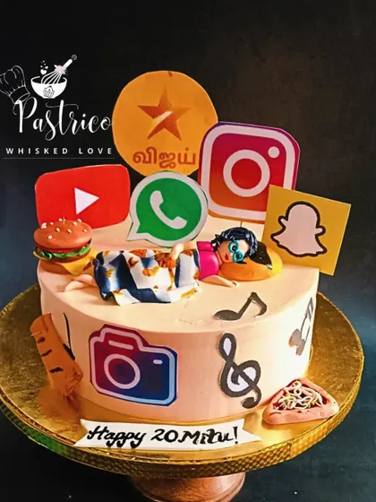 A personalized cake for a 20-year-old, decorated with all her favourite things, including social media logos, music notes, and food.