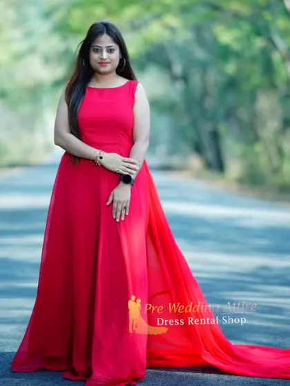 This simple yet elegant red trail gown features a side slit and a long, flowing tail. It's a versatile piece that works for both dramatic and understated photoshoots.