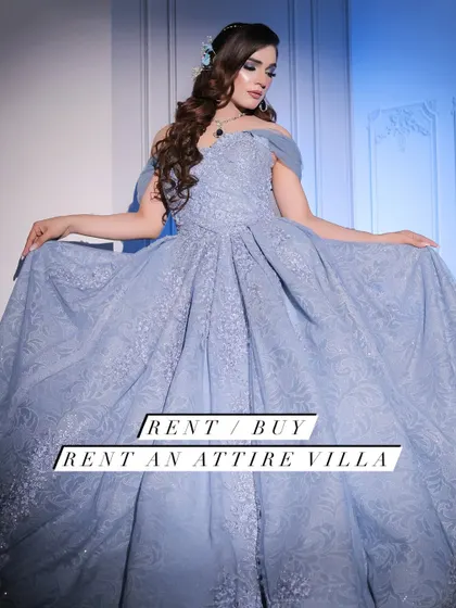 A professional shot of a model in my powder blue ball gown. The off-shoulder design and full, embroidered skirt create a timeless and elegant look, available for rent for your special occasion.
