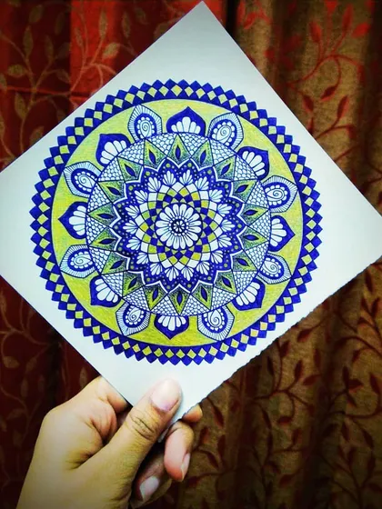 A colorful mandala created with violet and gold pens on watercolor paper. The combination of the rich violet ink and shimmering gold gives this piece a royal and uplifting feel.