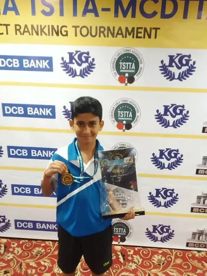 Aakarshan Yadav, our U-11 Boys champion, proudly displays his trophy and medal at the TSTTA-MCDTTA district tournament. We focus on building a strong foundation from a young age.