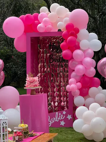 Come on Barbie, let's go party! This Barbie-themed setup features a life-size doll box photo booth with a shimmer backdrop, perfect for creating iconic photos.
