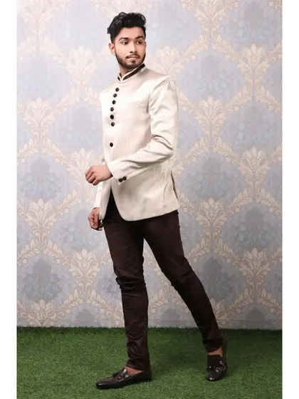 For male models, showcasing a range of looks is crucial. This shot features a model in a sophisticated off-white Jodhpuri suit, demonstrating his suitability for high-end ethnic wear and formal events.