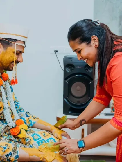 A sister's playful participation in her brother's Haldi ceremony, a candid moment of sibling love.