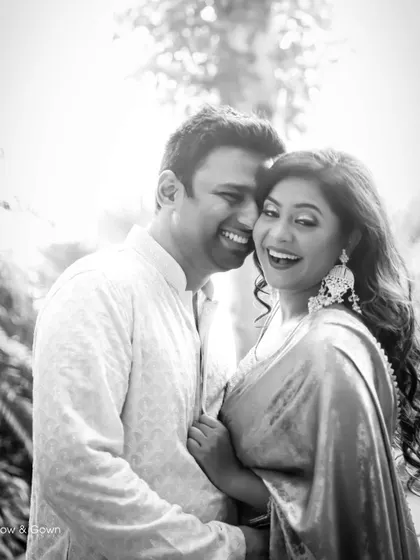 A classic black and white portrait capturing a moment of shared laughter during a Roka ceremony. Their genuine happiness is the focus of this timeless image.