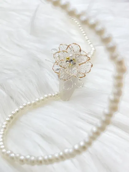 A wider view of the 3D flower, presented with a string of pearls to emphasize its elegance and suitability for bridal or formal occasions.
