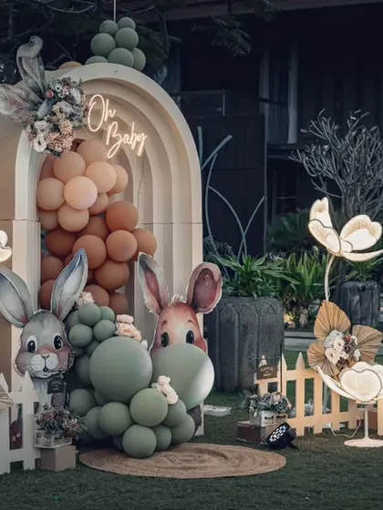 The full "Bunny & Berries" baby shower setup at night. The lighting design is crucial and creates a completely different, magical mood after sunset.