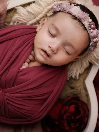 Dreaming in magenta. This close-up of a swaddled baby in a heart bowl shows the beautiful textures and colors I use in my sessions.
