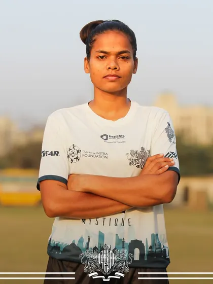 The focused look of a seasoned player. Her experience and composure are invaluable assets to the team on match day.