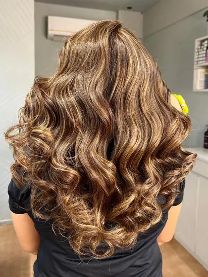 The back view shows the full effect of this beige blonde balayage. The color is seamless and the hair looks incredibly healthy and full.