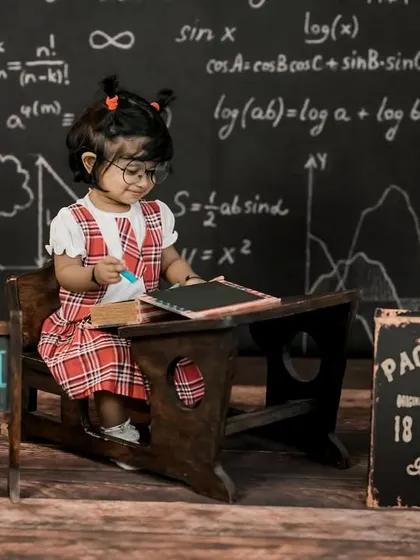 A focused little student cleaning her slate in our 'back to school' setup. We love capturing these candid, story-telling moments.