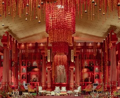 The groom awaits his bride in the spectacular red temple-like setting we created from scratch.