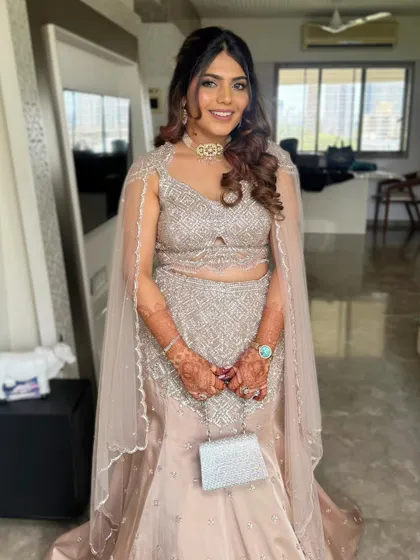 For this cocktail look, I styled the hair in a half-updo with soft, flowing waves that complement the sparkling silver lehenga.