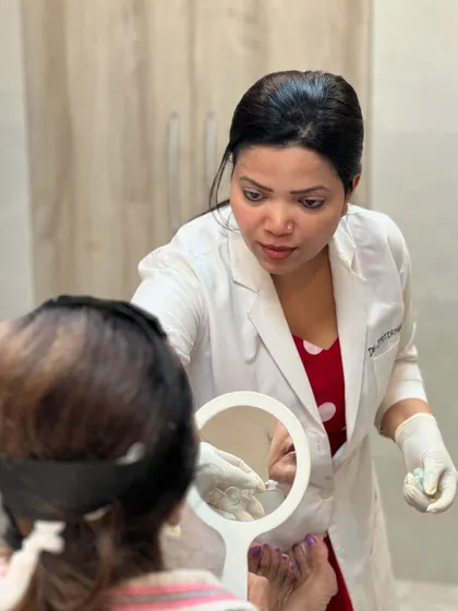 A close-up of the consultation process for fillers. Using a mirror, I help the client visualize how adding subtle volume can lift and support the facial structure for a natural-looking enhancement.