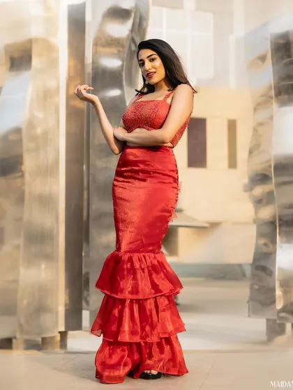 The winner of Times Fresh Face 2024 wearing a custom red Kalasthree outfit. The mermaid silhouette is both modern and dramatic.