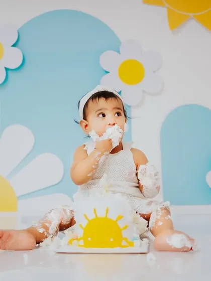 A moment of sweet contemplation before the next handful of cake. These sessions are full of different expressions, from excitement to curiosity.