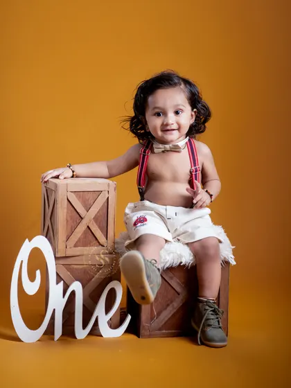 Celebrating the big "One"! This first birthday milestone shoot features a fun, rustic theme with a bold yellow background that makes your little one the star of the show.