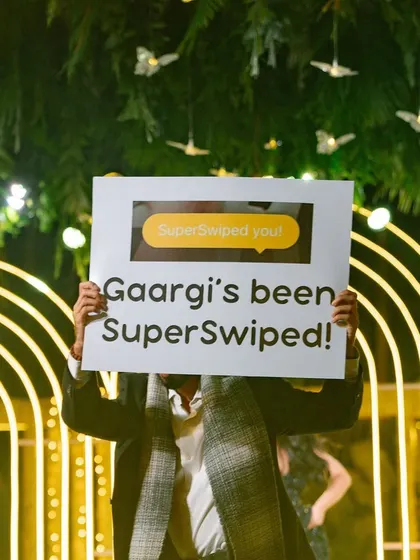 A prop sign showing a "SuperSwiped" notification, creatively telling the story of how the couple met online.