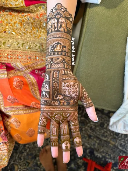 A close-up of one hand, detailing the tiny elephants on the fingers and the graceful swan on the wrist.