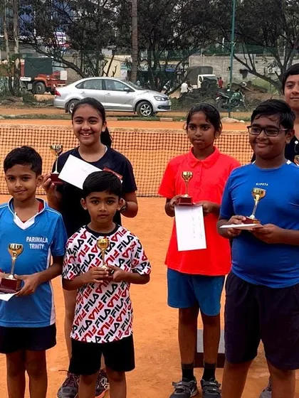 Celebrating the success of our young players at a local tournament. It's a proud moment to see their hard work pay off with trophies and certificates. This is what our youth tennis match-play training prepares them for.