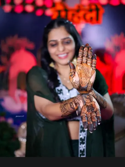 A creative pose showing off the groom's portrait on one palm and the bride's on the other.