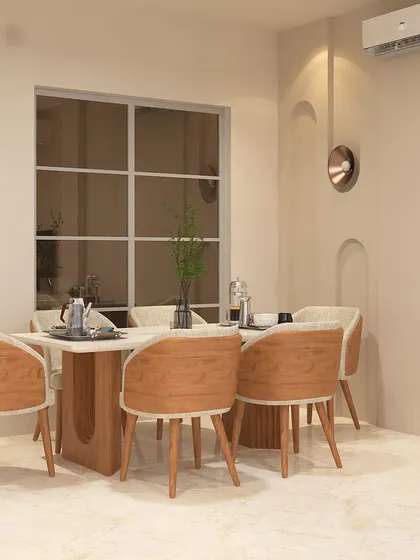 A six-seater dining table with a solid wood-finish base and chairs. The simple wall paneling with arched grooves and a copper accent light adds a touch of minimalist elegance to the space.