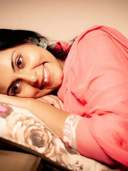 A sweet and joyful expression. This relaxed, lying-down pose creates an intimate and friendly portrait.