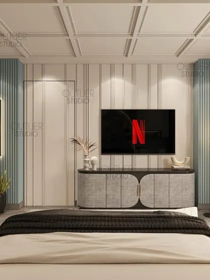 Calling all Netflix enthusiasts. This bedroom features a cool blue and white color palette, with a media wall that is both simple and stylish, perfect for a modern, relaxed vibe.