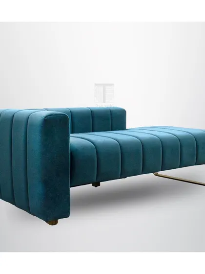 The angled view of the teal chaise shows its strong, geometric lines and plush upholstery.