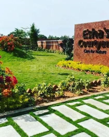 The completed entrance at Esha's Courtyard showcases our work with lawns, layered flower beds, and hardscaping to create a beautiful and professional look for the property.