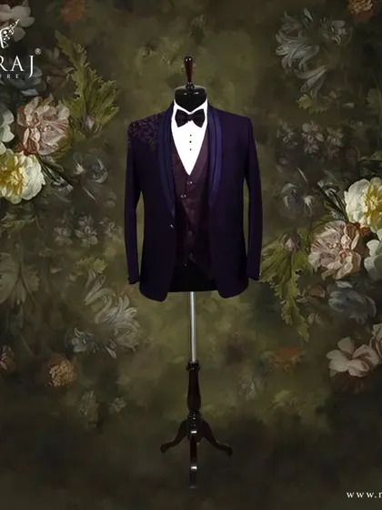 This purple Italian suit is for the groom with a flair for the dramatic. The design features a floral patterned vest and subtle self-color embellishments on the shoulder, offering a look that is both regal and contemporary.