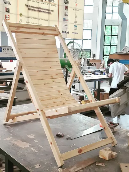 A classic deck chair built with solid wood, a popular student project that teaches angled cuts, joinery, and assembly for outdoor furniture.
