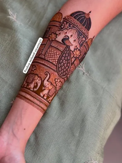 A close-up of a forearm band featuring a peacock in a jharokha and a procession of elephants. This shows how I build up a full bridal design layer by layer.