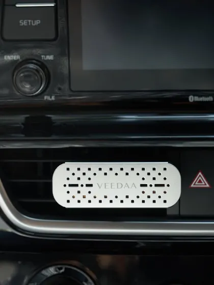 Our car fragrance vent clip, attached to a horizontal air vent. Its versatile design works with both vertical and horizontal vents, making it a perfect fit for any car.