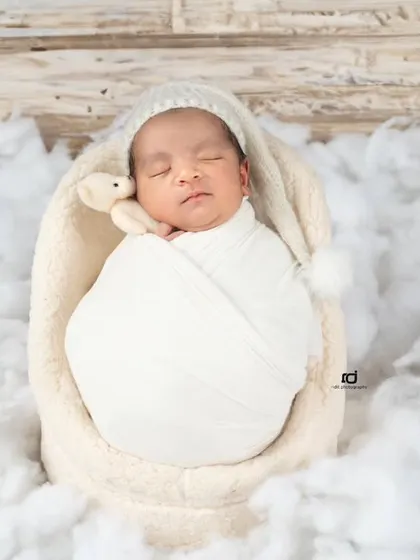 Drifting away on a soft cloud of cotton. I love using simple textures and a cozy knit hat to keep the focus on the baby's peaceful expression.
