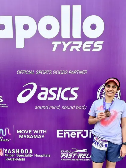 Posing with my medal after the Apollo Tyres New Delhi Marathon, sponsored by Asics.