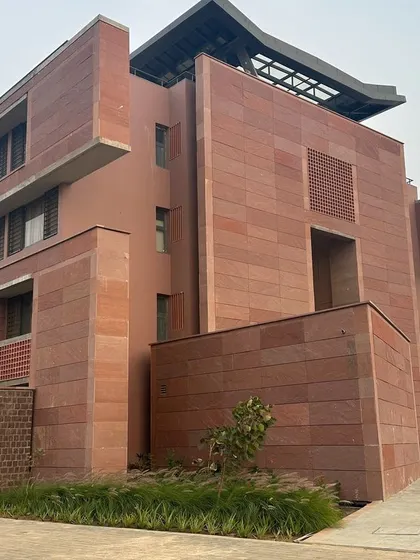 The facade of the Azim Premji University building, showing the use of local sandstone and a design that responds to the local climate.