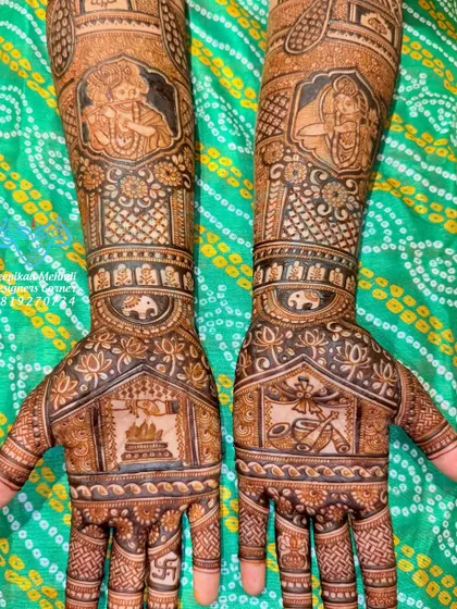 A design filled with spiritual significance. This mehndi features portraits of Lord Krishna and Meera Bai on the forearms, with a havan kund (sacred fire) and a tulsi plant on the palms, representing devotion and purity.